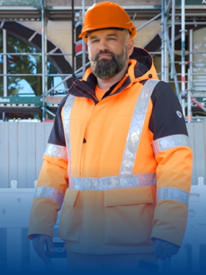 A construction worker on a building site wears BP® high-visibility clothing.
